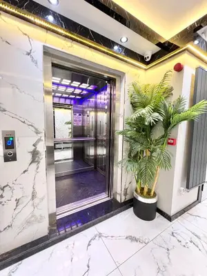 an elevatorexit in a building with a palm plant at Taksim Larissa hotel suites in Istanbul