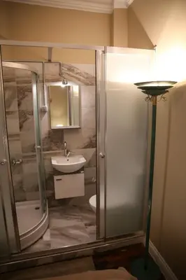 a bathroom with a shower and a toilet and a sink at Agus Flats Galata in Istanbul
