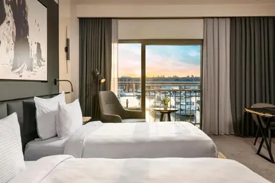 a hotel room with two beds and a balcony at Crowne Plaza Istanbul Tuzla Viaport Marina by IHG in Istanbul