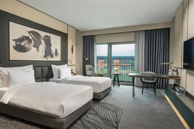 a hotel room with two beds and a television at Crowne Plaza Istanbul Tuzla Viaport Marina by IHG in Istanbul