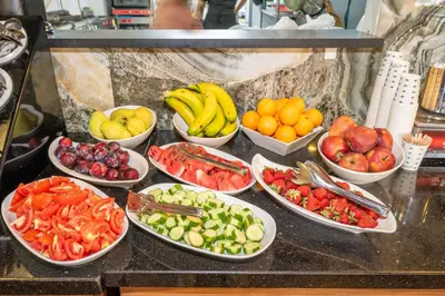 a bunch of bowls of fruit and vegetables on a counter at Litros Hotel & Spa in Istanbul