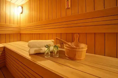 a sauna with a bucket and towels on a shelf at Stargate Hotel&Spa in Korfez