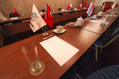 a long wooden table in a restaurant with flags at Stargate Hotel&Spa in Korfez