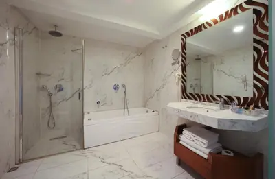 a bathroom with a tub and a shower and a sink at Stargate Hotel&Spa in Korfez