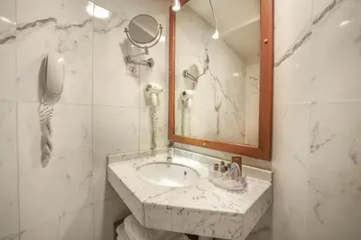 a bathroom with a sink and a mirror and a phone at Stargate Hotel&Spa in Korfez