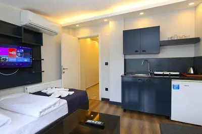 a small room with a bed and a kitchen at Galata King Suites in Istanbul
