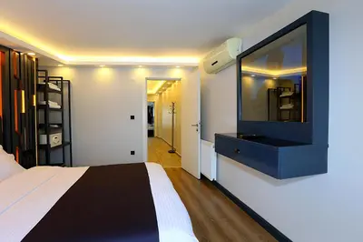 a bedroom with a bed and a tv on the wall at Galata King Suites in Istanbul
