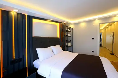 a bedroom with a large bed with white pillows at Galata King Suites in Istanbul
