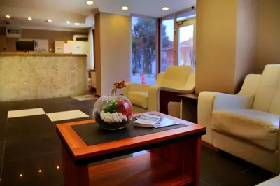 a living room with a table with a vase on it at Miletus Otel Şile in Sile