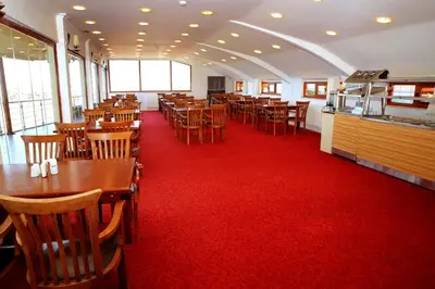 a dining room with tables and chairs on a red carpet at Miletus Otel Şile in Sile