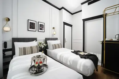 two beds in a room with white walls at The Trinity Hotel Taksim - Special Category in Istanbul