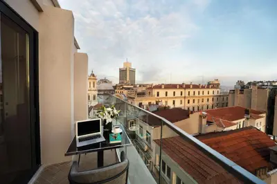 a laptop computer sitting on a table on a balcony at The Trinity Hotel Taksim - Special Category in Istanbul