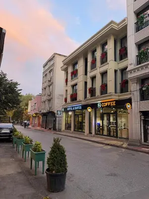 a city street with buildings and potted plants at KA Hotel & Suites in Istanbul