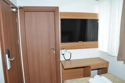 a room with a door with a desk and a television at Hotel La SERA in Istanbul