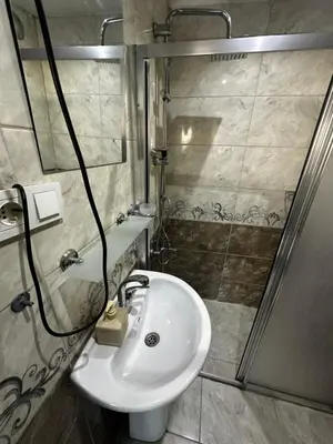 a bathroom with a sink and a shower at yakut old hotel in Istanbul