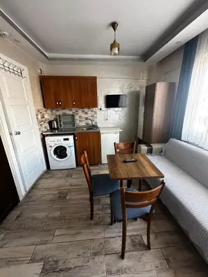 a small living room with a table and a couch at yakut old hotel in Istanbul