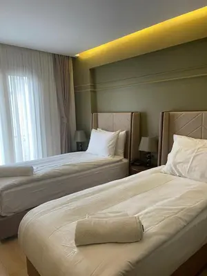 two beds in a hotel room with a towel on the bed at The Biancho Hotel Old City - Special Category in Istanbul