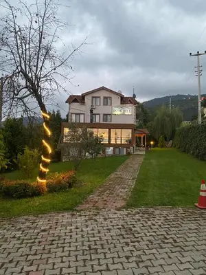 a house with a light pole in the yard at SNOW HİLL HOUSE Pansiyon in Kartepe