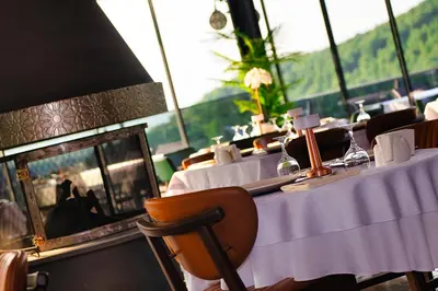 a dining room with tables and a fireplace in a restaurant at Vela Verde Hotel & SPA in Yalova