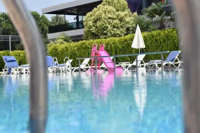 a pool with a pink slide in a swimming pool at Vela Verde Hotel & SPA in Yalova