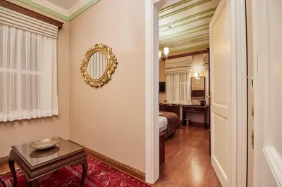 a room with a bed and a table and a mirror at White Palace Old City Boutique Hotel in Istanbul