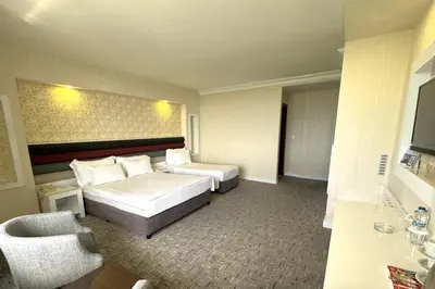 a hotel room with a bed and a chair at Tekirdağ Yat Hotel in Tekirdag