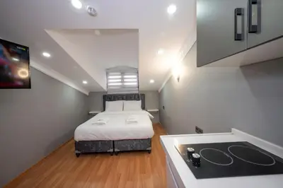 a small bedroom with a bed and a sink at Taxim Sunpera Suites in Istanbul