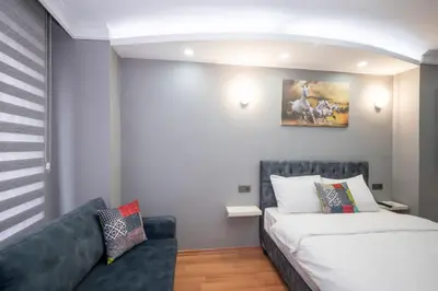 a living room with a bed and a couch at Taxim Sunpera Suites in Istanbul