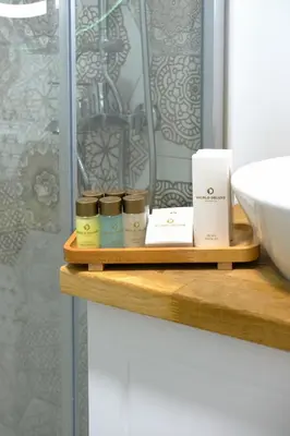 a shelf with three candles on it next to a sink at World DREAMS Sapanca in Sakarya