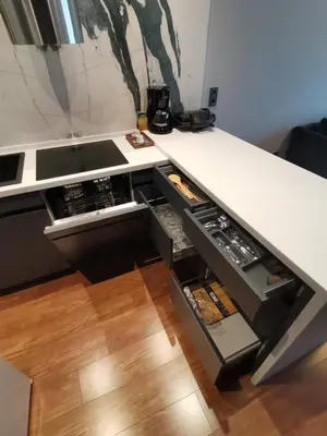 a kitchen with a white counter top with open drawers at BENESTA BEYOGLU in Istanbul