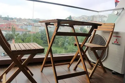 a desk and a chair in front of a window at BENESTA BEYOGLU in Istanbul