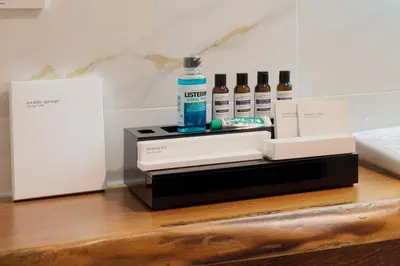 a bottle of alcohol sitting on top of a table at İzz Hotel Koşuyolu in Istanbul