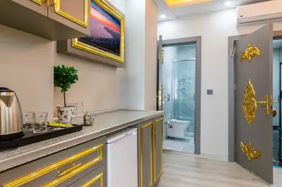 a kitchen with a counter top and a bathroom at Santa Rio Taxim in Istanbul