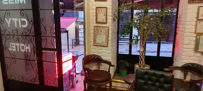a room with two chairs in front of a window at Miss City Hotel Taksim in Istanbul