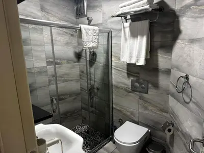 a bathroom with a shower with a toilet and a sink at Miss City Hotel Taksim in Istanbul