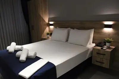 a bedroom with a large bed with white sheets and pillows at Kassimo Hotel in Istanbul