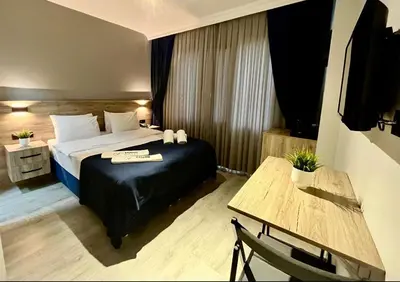 a hotel room with a bed and a table at Kassimo Hotel in Istanbul