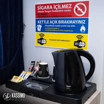 a black coffee pot sitting on top of a microwave at Kassimo Hotel in Istanbul