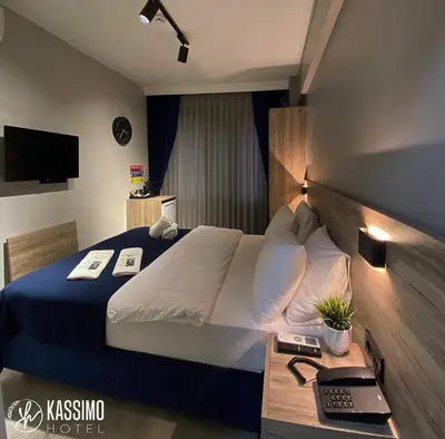 a hotel room with a bed and a television at Kassimo Hotel in Istanbul