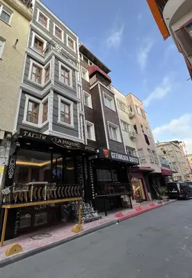 a building on a street with a bench in front at Taksim La Marino Hotel in Istanbul