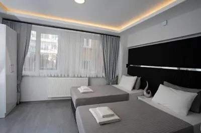 a hotel room with two beds and a window at Carvan HOTEL in Istanbul