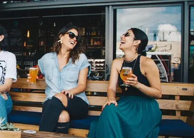 two women sitting on a bench with drinks at Kalkedon Plus in Istanbul