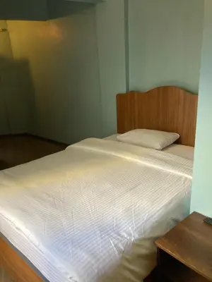 a bedroom with a large white bed with a wooden headboard at Ulusoy Old Cıty in Istanbul