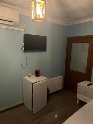 a bedroom with a television and a small refrigerator at Ulusoy Old Cıty in Istanbul