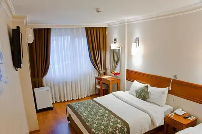 a hotel room with a bed and a window at Avlonya Hotel in Istanbul