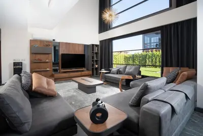 a living room with a couch and a tv at Andalus Villas NO ALCOHOL ALLOWED with Heated Pool in Sapanca