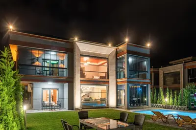 a large house with a pool at night at Andalus Villas NO ALCOHOL ALLOWED with Heated Pool in Sapanca