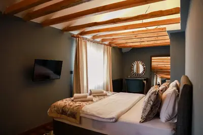 a bedroom with a large bed with a wooden ceiling at Adess Otel in Çekmeköy