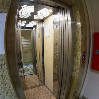 a mirror in a hallway with a reflection of a room at Ottoman Time Hotel in Istanbul