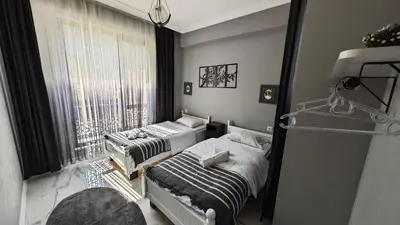 a bedroom with two beds and a window at family villas 2 in Sapanca